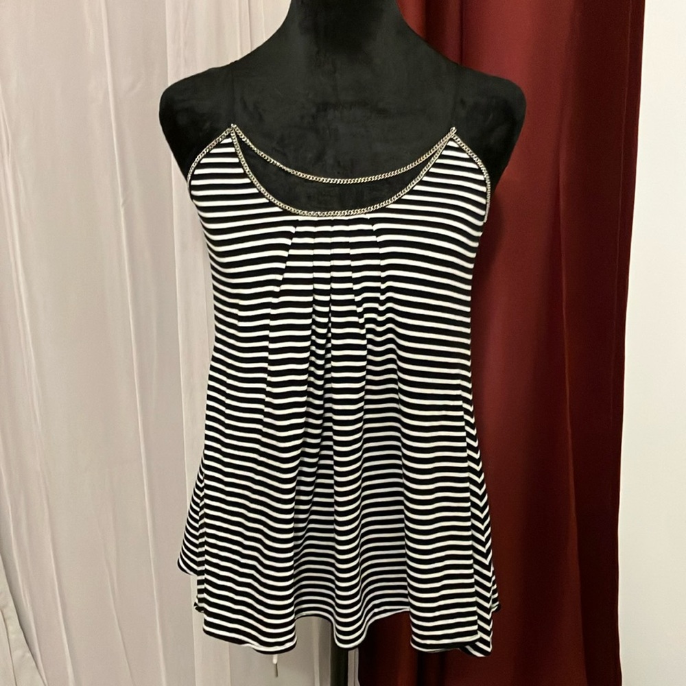 A beautiful spaghetti strap blouse with a built in necklace on the front.